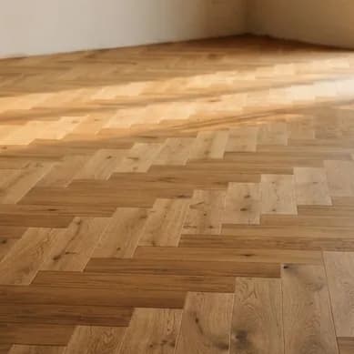 Chevron in smoked oak: every board mitred at forty-five degrees.